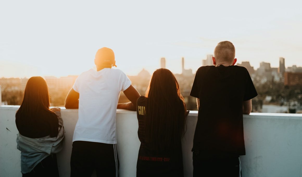 four person looking at the city