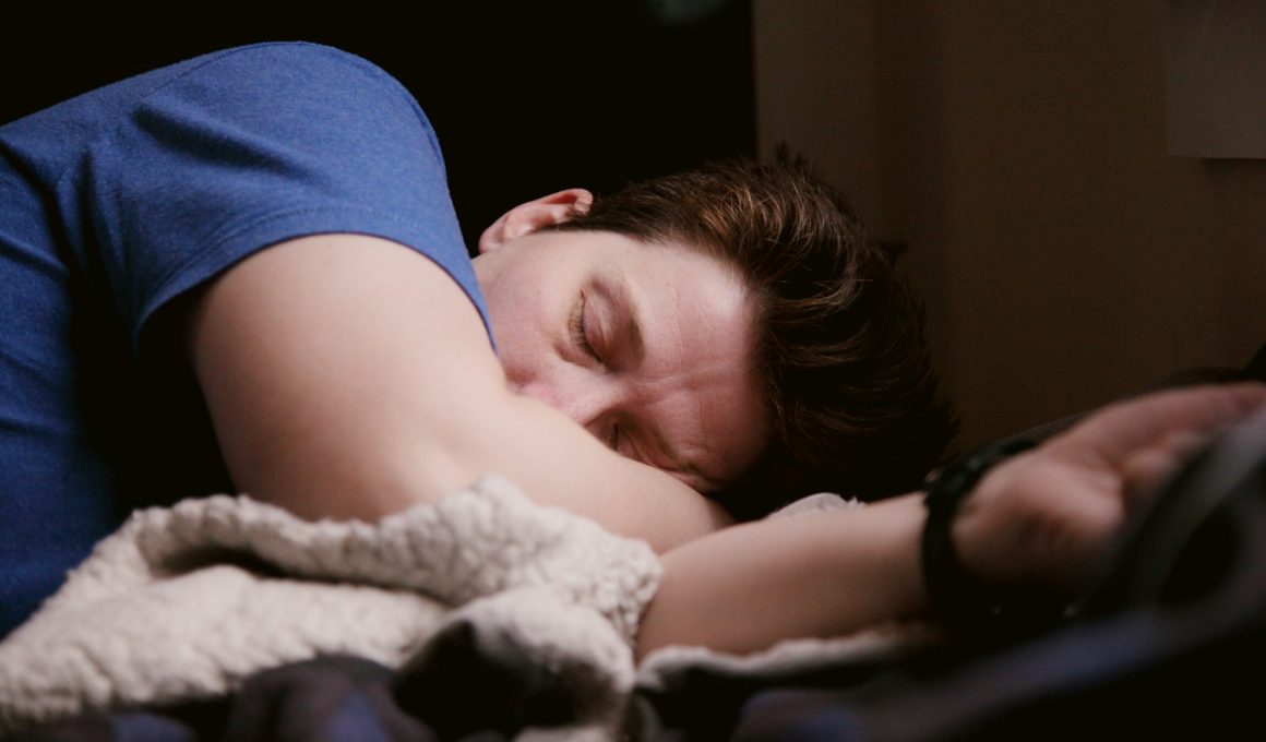 woman in blue shirt lying on bed