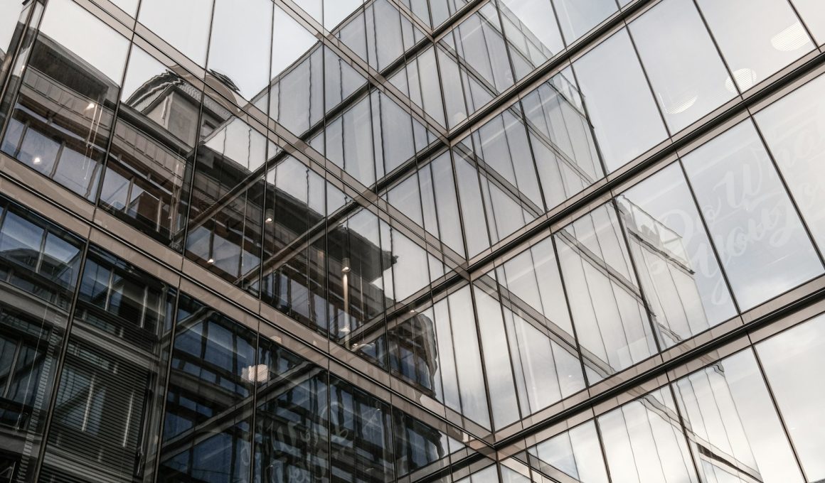 the reflection of a building in the windows of another building