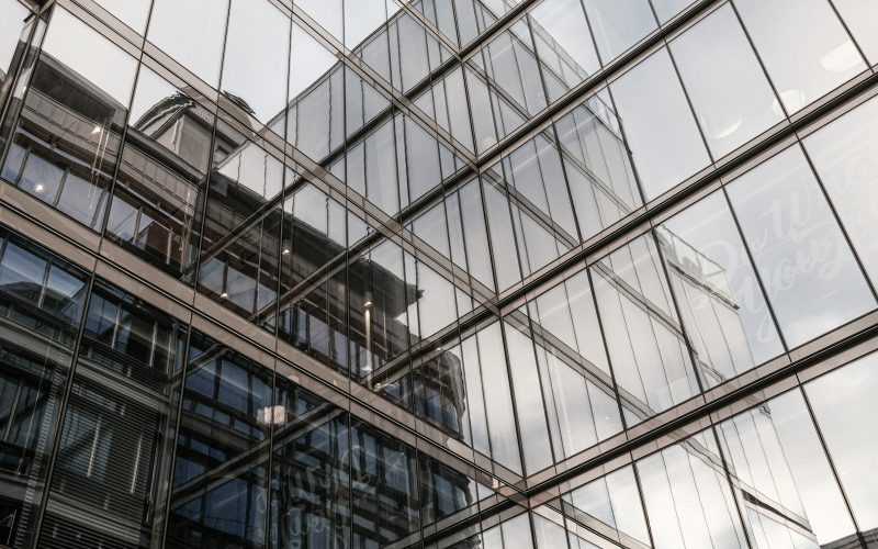 the reflection of a building in the windows of another building