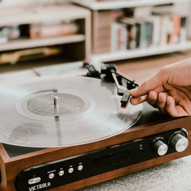 person playing record on Victrola turntable