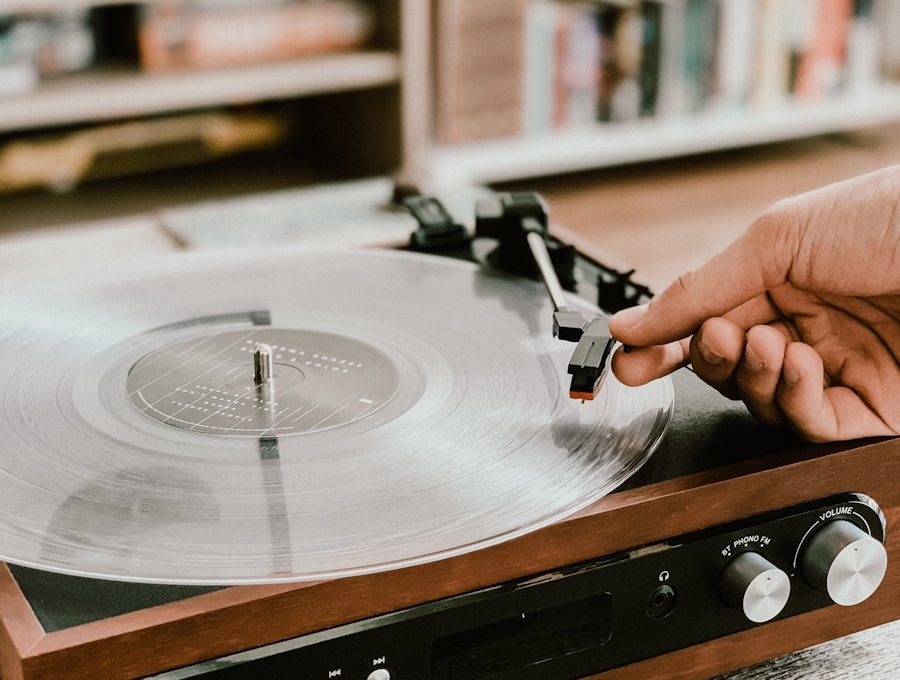 person playing record on Victrola turntable