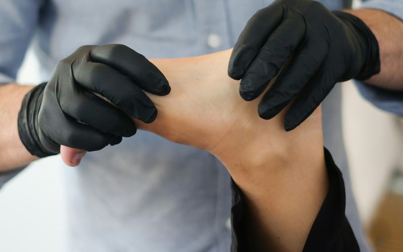 person massaging other person's foot