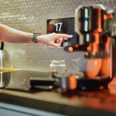 a person pressing a button on a coffee machine