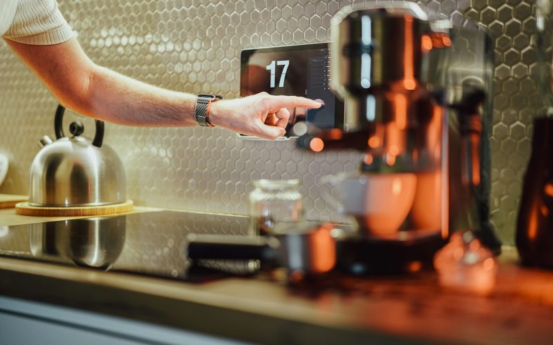 a person pressing a button on a coffee machine