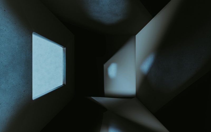 a dark room with a small window in it