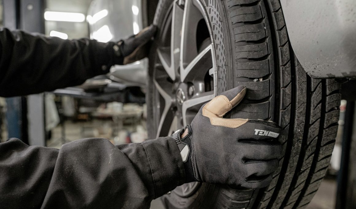 a man working on a tire in a garage