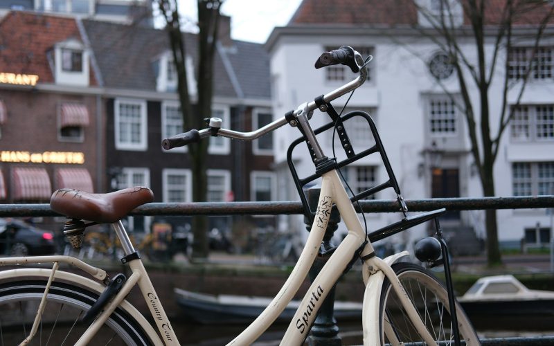 a bicycle parked next to a metal fence