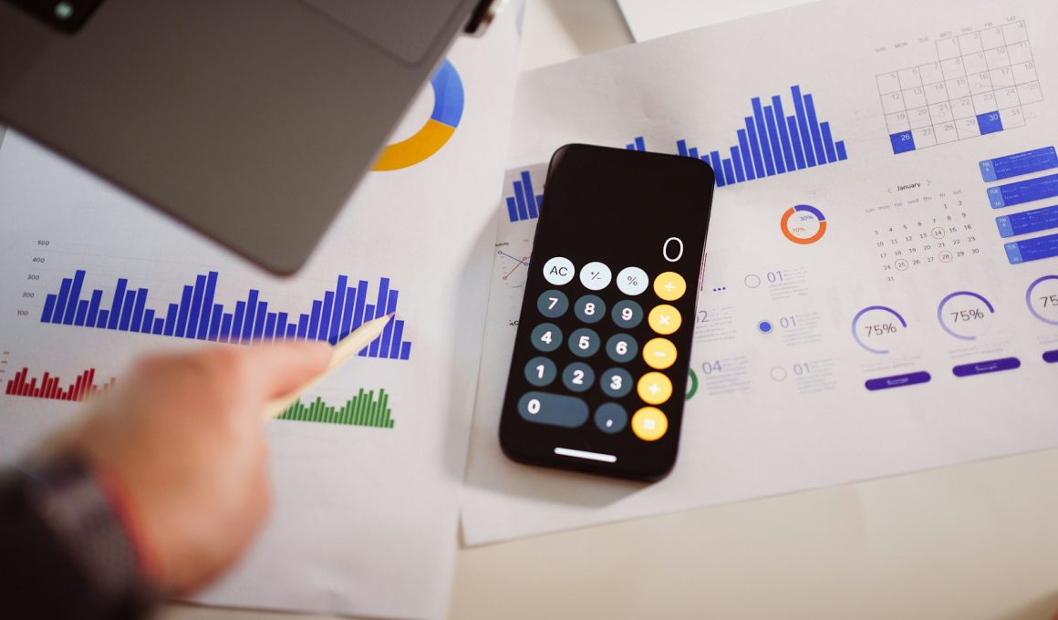 a calculator sitting on top of a table next to a laptop