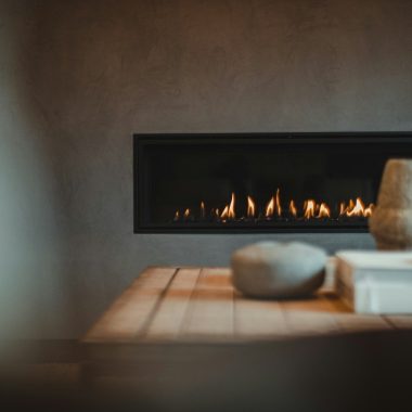 a table with a vase and a fire place on it