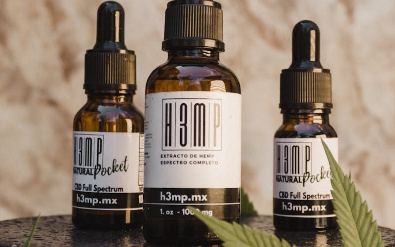 CBD oil bottles with droppers and hemp leaf on display in Tijuana, Mexico. Ideal for wellness and natural remedy themes.