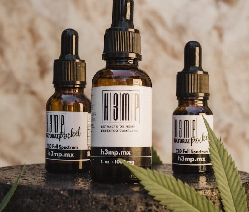 CBD oil bottles with droppers and hemp leaf on display in Tijuana, Mexico. Ideal for wellness and natural remedy themes.