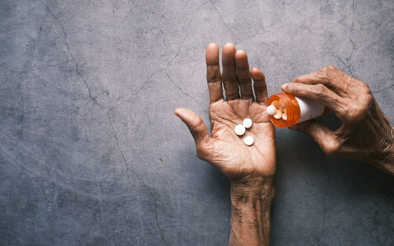 person holding white round ornament
