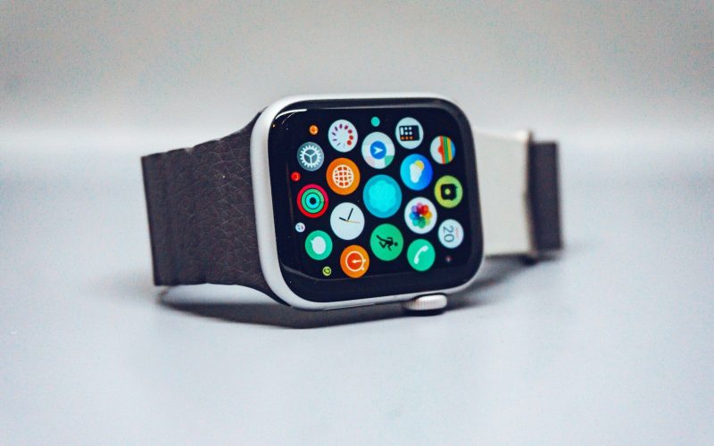 A smartwatch with a dark textured band and a colorful app icon display